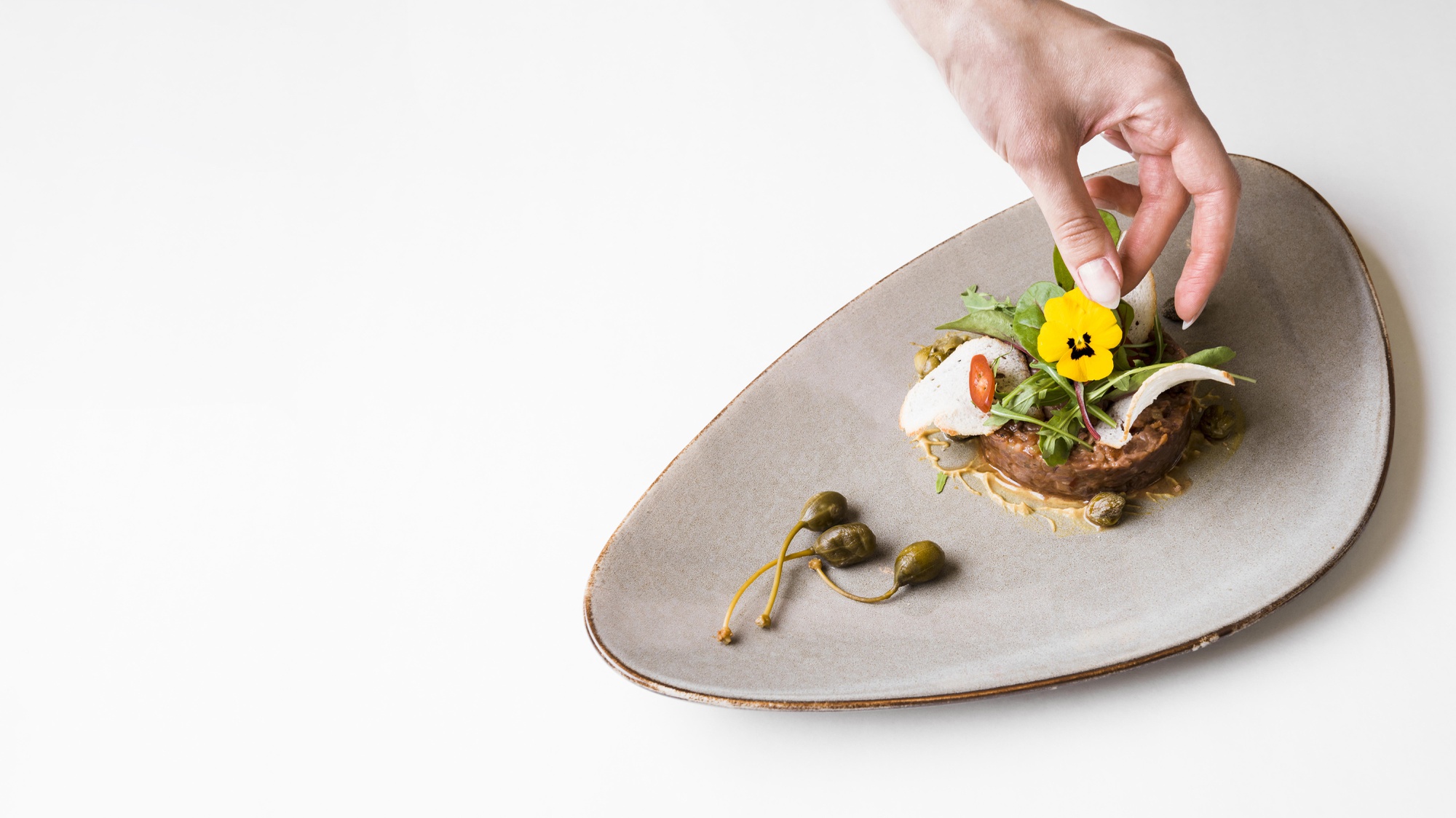 Instructor preparing plated dish in studio